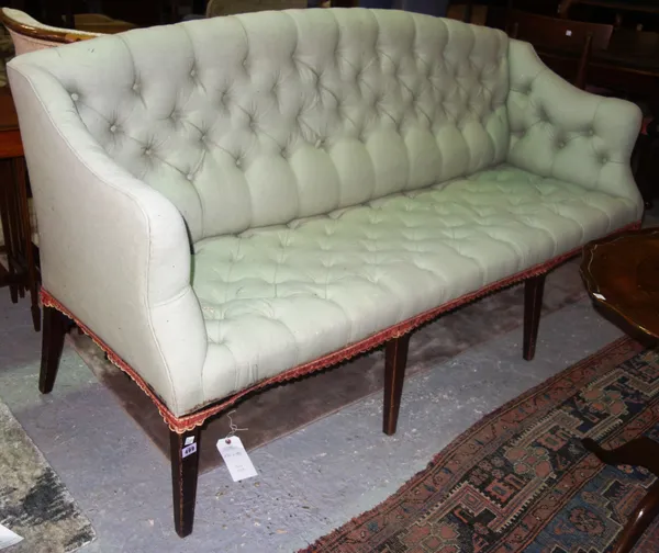 A George III style humpback sofa, with button upholstery on tapering square mahogany supports (one back leg missing), 95cm high.  N7