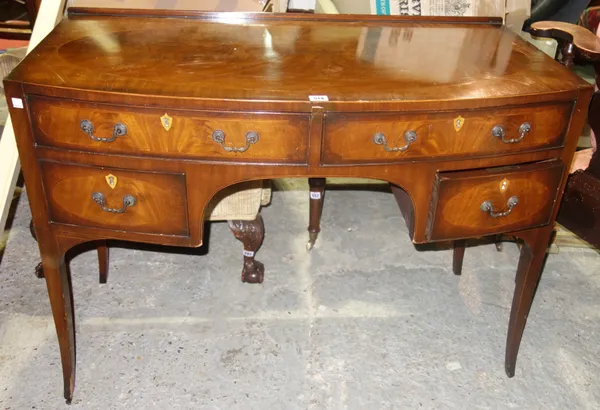 A late 19th century inlaid mahogany bowfront writing table, with four frieze drawers on splayed supports, 107cm wide.  L5