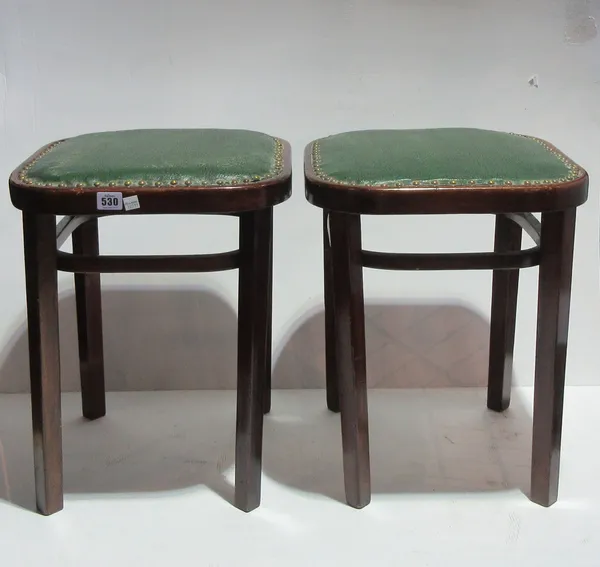 A pair of early 20th century Thonet Bentwood footstools, on tapering square supports, each 38cm wide, (2). D10
