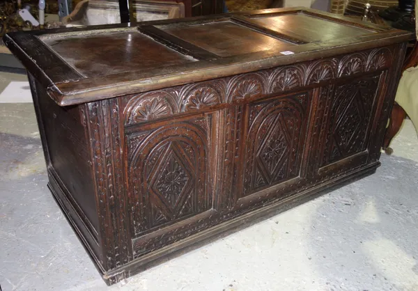 A 17th century and later oak coffer with carved triple panel front, 114cm wide.  K4