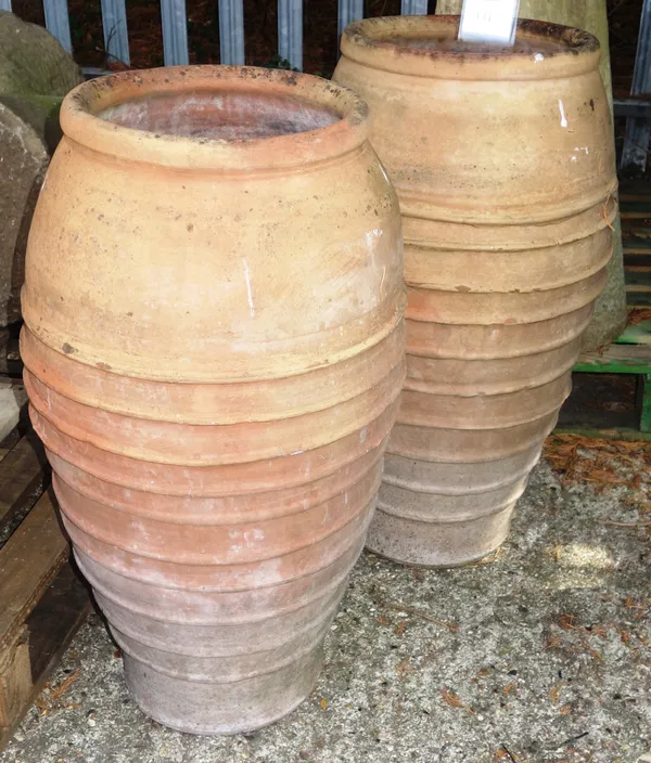 A pair of terracotta garden pots with ribbed bodies, each 75cm high, (2).  OUTSIDE