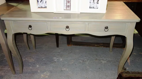 OKA; A 20th century grey/ green painted three drawer side table on cabriole supports, 122cm wide.   F8