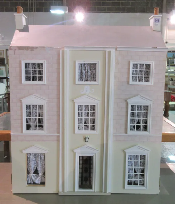 A 20th century dolls house in the form of a Georgian three storey town house, 75cm wide.    F8