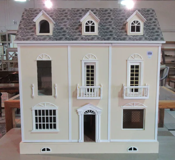 A 20th century dolls house in the form of a French three storey town house, 80cm wide.   F8