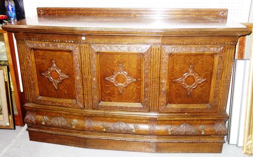 An early 20th century oak bowfront sideboard, with three panelled cupboards over three drawers, 168cm wide.  ROST