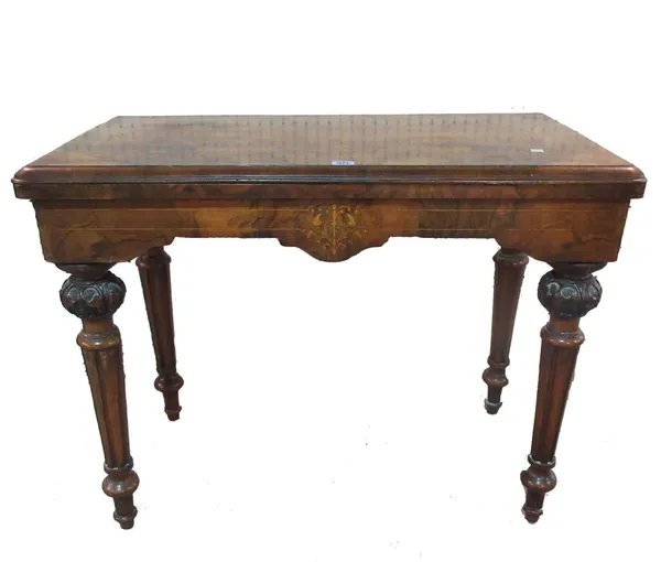 A Victorian walnut and inlaid fold over card table, on turned tapering supports, 90cm wide.   E4