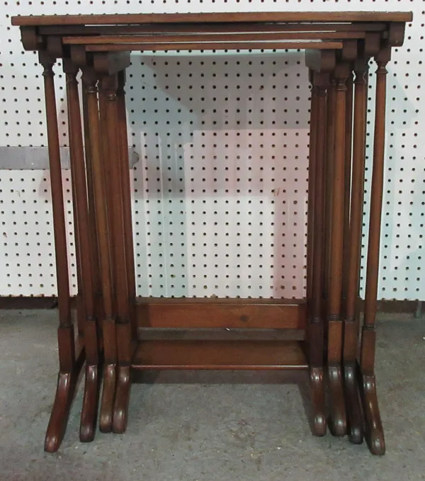 An Edwardian nest of four mahogany and crossbanded occasional tables, the largest 57cm wide.  K11