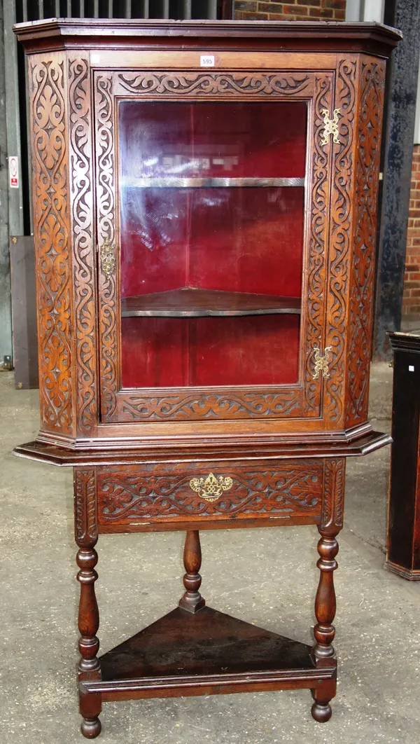 An 18th century oak corner display cabinet with carved decoration, 86cm wide x 176cm high.   H9