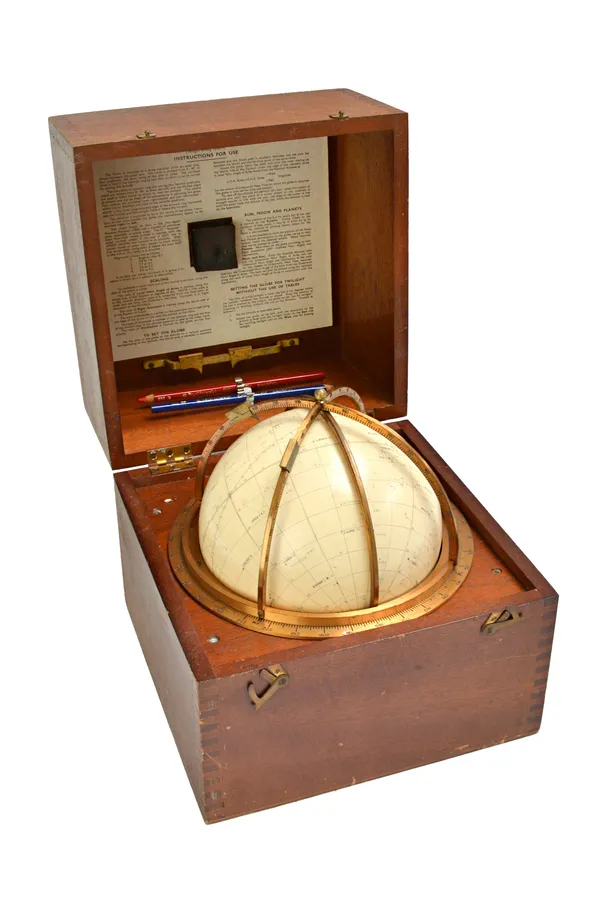 A Kelvin Hughes star globe, Epoch 1975, the globe set within lacquered brass horizon and meridian rings, with instructions to the lid interior, contai