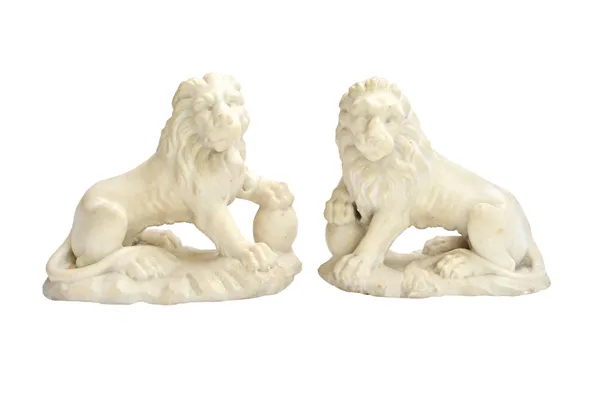 A pair of Italian marble lions, early 19th century, with paws raised on balls, on shaped naturalistic bases, 20cm high, (2).  Illustrated