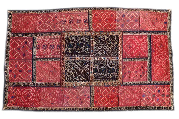 An Uzbek flatweave hanging panel, composed of joined sections of various red and black ground panels with scrolling stitch work in assorted designs, 2