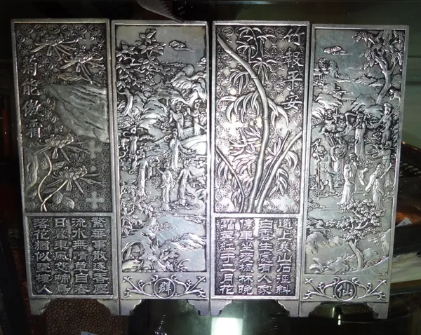 A set of four Chinese white metal plaques in the form of a table screen, each 4.5cm wide x 14cm high, (4).  CAB