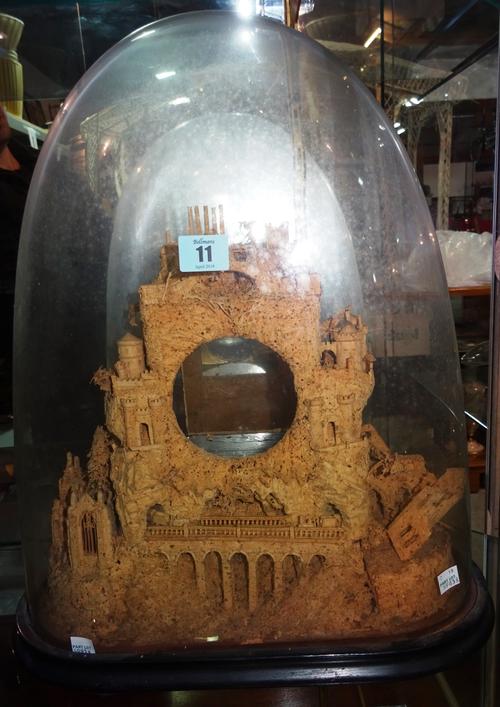 A 19th century carved cork clock case of architectural form under a glass dome. 49cm tall. CAB