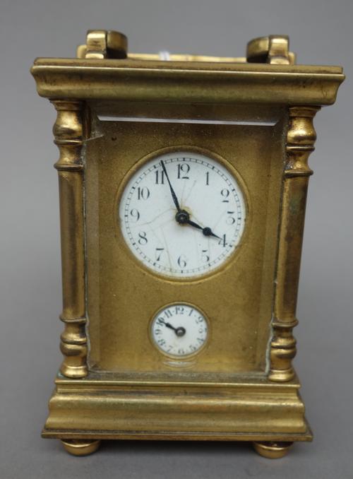 An early 20th century miniature brass cased carriage clock, with subsidiary alarm dial, a single train movement and a leather travel case, 8.5cm high,