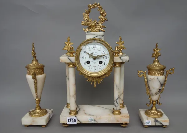 A French marble and gilt metal mounted mantel three piece clock garniture, late 19th century, the drum case supported by four pillars and set with a f
