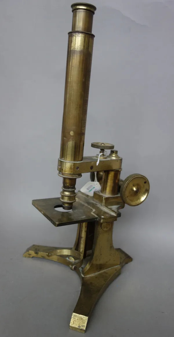 A Victorian gilt brass microscope by King and Coombs, Bristol, with rack and pinion focusing and fine adjustment over a triform foot, 37cm high, (a.f)