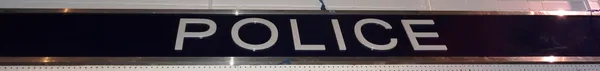 A 20th century metal framed rectangular 'Police' sign, 525cm wide x 48cm high.  CAB