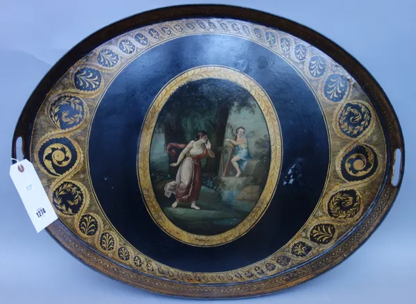 A Regency tole peinte oval two handled tray, centrally painted with Cupid playing a harp with a female attendant, within a gilt foliate wide border an
