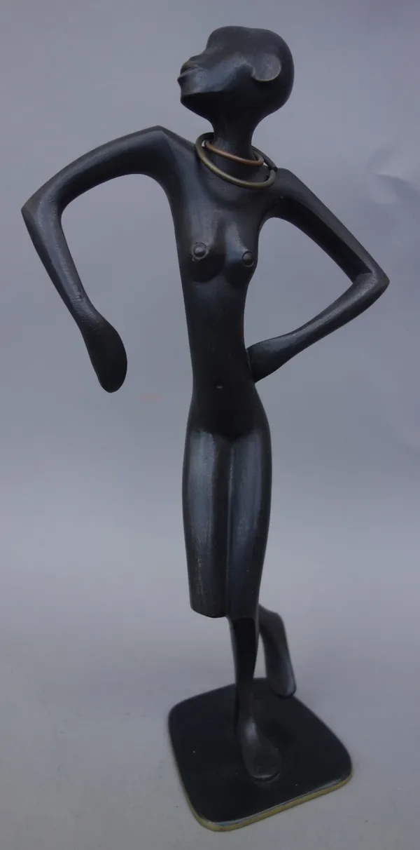 A Hagenauer patinated bronze African female nude figure, modelled dancing, with two necklaces, on a shaped base, stamped marks to the underside, 26.5c
