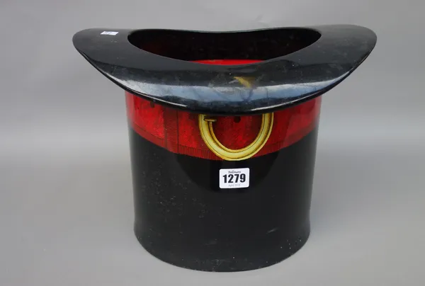 A Fornasetti tole peinte novelty ice bucket, circa 1980, modelled as a top hat with red buckled band, paper label to the base, 25.5cm high.
