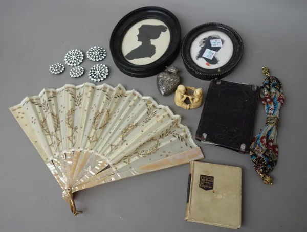 A quantity of collectables, including; two oval silhouettes, a silver heart shaped vesta, two fans, a Japanese ivory figural netsuke, dated 1882 (3.5c