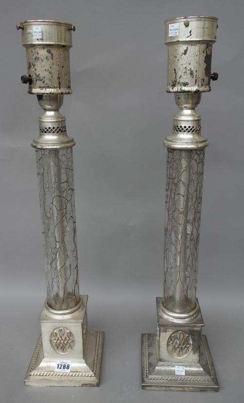 A pair of glass and silvered table lamps, late 20th century, each with craquelware glass column over a square silvered base, 65cm high, (2).