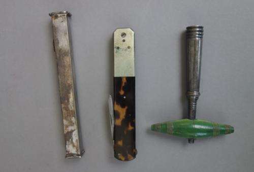 A silver sliding seal of square form, hallmarked, with matrix to one end, 10.5cm long, a travelling corkscrew, and a tortoiseshell eraser, (3).