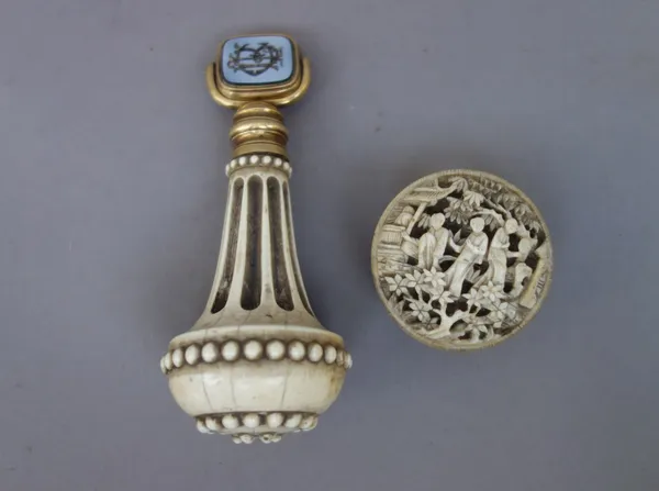 A Victorian ivory handled gilt metal seal inset with revolving double sided hardstone matrix, 10cm long, and a Chinese carved ivory trinket box, 3.8cm