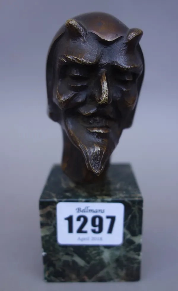 A Continental bronze bust, early 20th century, depicting the Devil, indistinctly signed and mounted on a green vein marble plinth, 13cm high, together