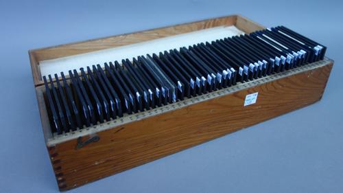 A quantity of pre-war three inch glass lantern slides depicting various ships and boats, contained in two wooden fitted cases, (approximately 95).