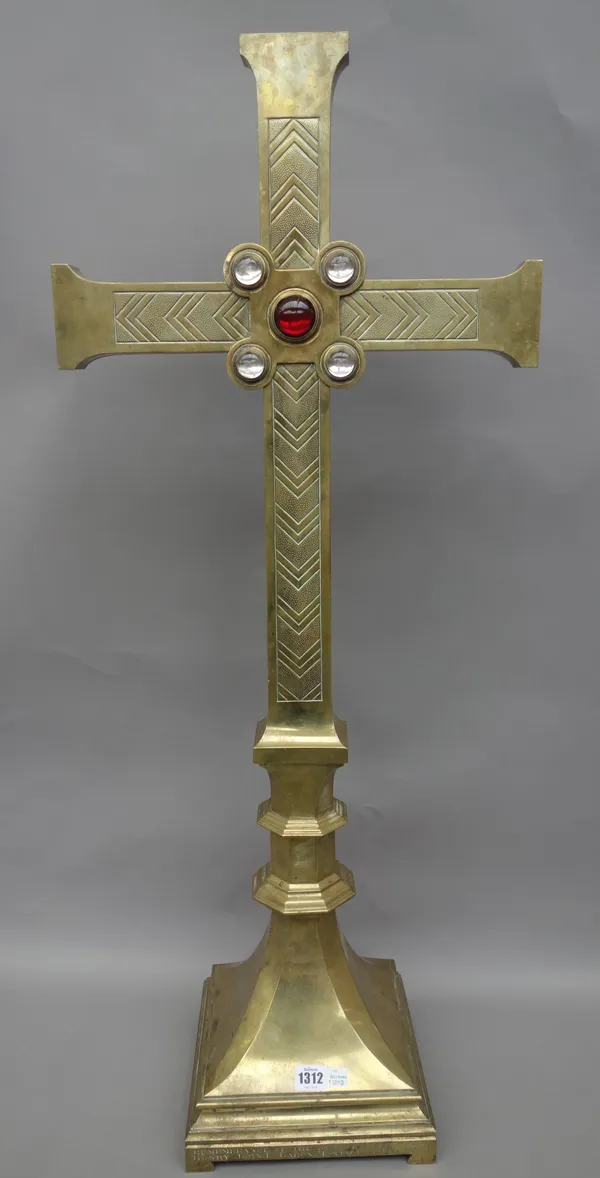 A Victorian brass altar crucifix, of Gothic form, decorated with five inset glass cabochons, over an engraved square foot, dated 1891, in remembrance