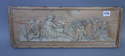 An early 19th century lime wood and pine chimney piece surmount, carved with a classical harvesting scene, 53cm wide, an Archaic bronze triform vessel