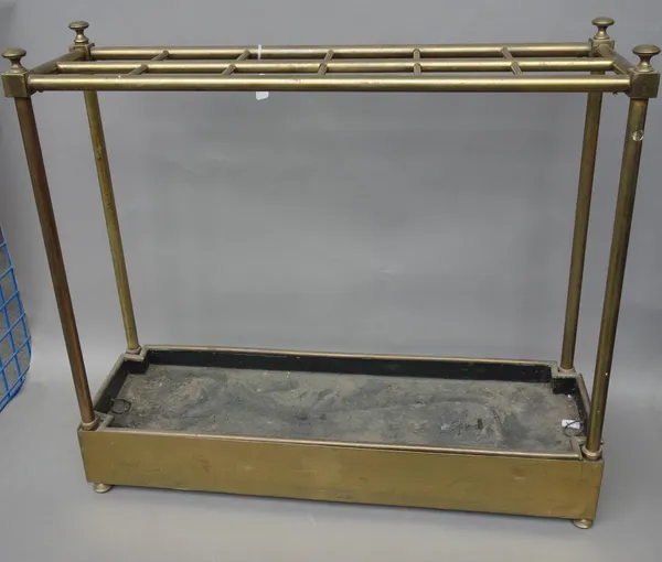 An Edwardian brass tubular twelve division stick stand, of rectangular form, with shaped removable drip tray, 74cm wide x 66cm high.