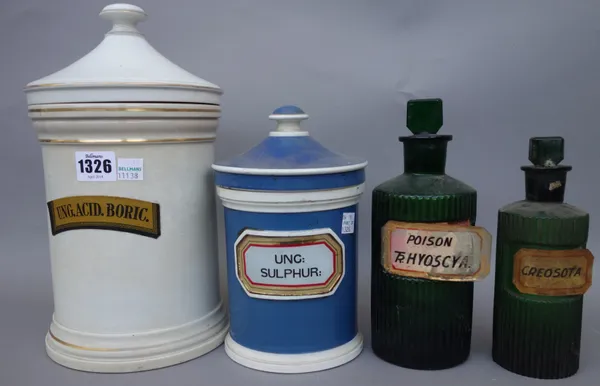 Two Shelly pottery jars and covers, each of cylindrical form, with gilt medicine labels, 26.5cm high, one smaller blue jar and cover, and eighteen gre