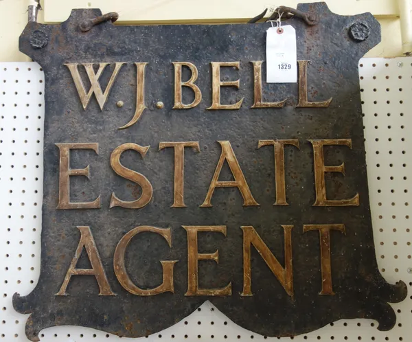 A wrought iron double sided hanging sign, 'W.J. Bell Estate Agent', circa 1920, with hanging bracket, 74cm wide x 65cm high     Footnote: formerly han