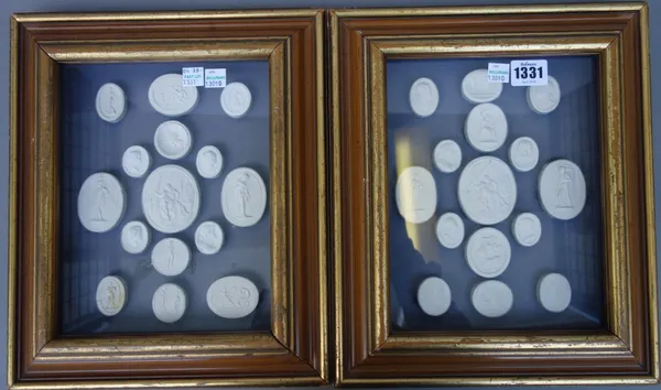 A quantity of plaster intaglios, 20th century, mounted in two glazed frames.