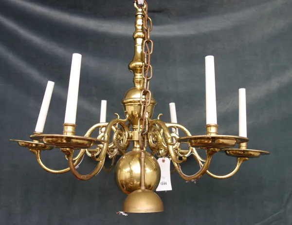 A Dutch brass six branch chandelier, with bulbous stem issuing six dolphin scroll supports, 75cm high.