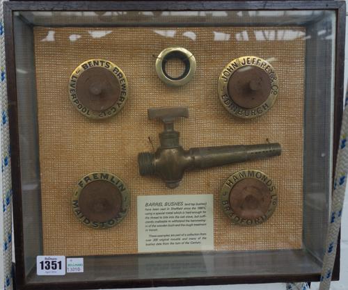 A quantity of antique brass barrel bushes and tap bushes, late 19th/early 20th century, mounted in three glazed frames, 41cm wide, (3).