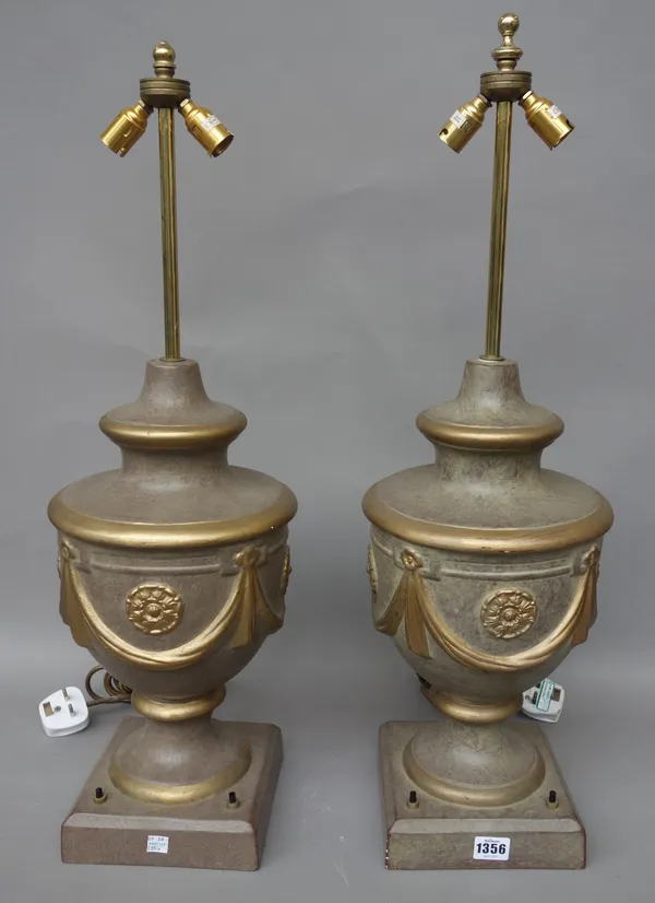 A pair of pottery table lamps, modern, of gilt swagged urn form, with cream silk pleated shades, 44cm high excluding fitments, (2). After-sale