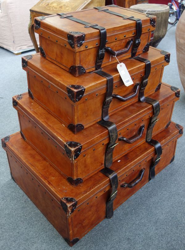 A set of four Victorian style graduated leather bound suitcases, modern, with metal studded detail and twin straps, the largest 93cm wide, (4).  Illus