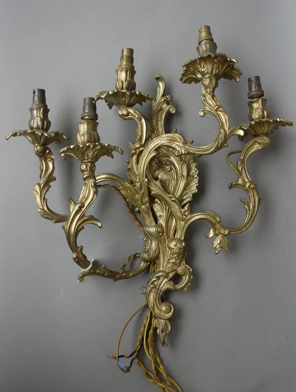 A set of four Victorian style gilt brass five branch wall appliques, 20th century, each of foliate cast form, 44cm high, (4).