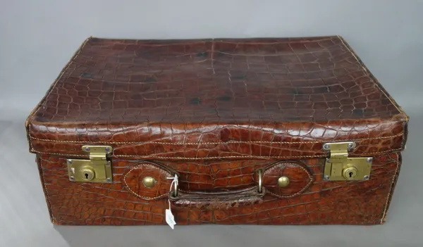 Three associated crocodile skin suitcases, early 20th century, the largest 60cm wide, (3).