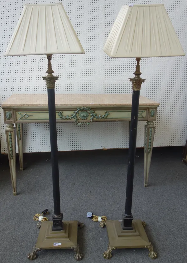 A pair of Victorian style brass standard lamps, 20th century, each of Corinthian column form, with square cream silk pleated shades, 160cm high, (2).