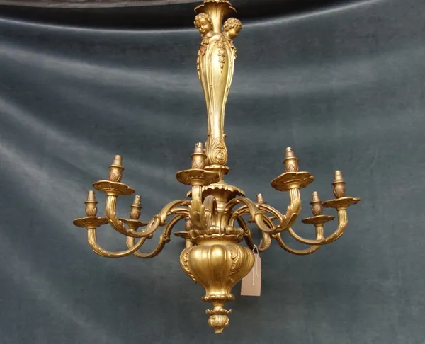 A Victorian style gilt bronze nine branch chandelier, the stem cast with putto masks over a foliate cast finial, issuing nine swan neck branches, 90cm