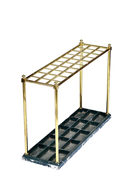 An Edwardian gilt brass tubular thirty division stick stand, on a cast iron painted base, 102cm wide x 71cm high x 33cm deep.  Illustrated