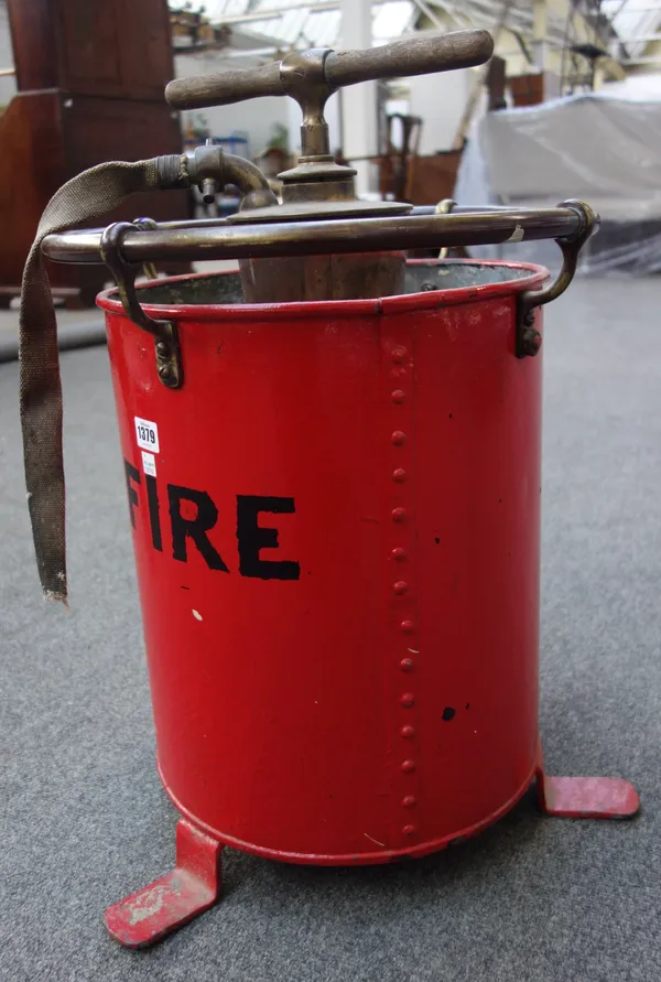 An early 20th century red painted fire extinguisher, with brass tubular top rail, 65cm high, and one further copper and brass mounted fire extinguishe