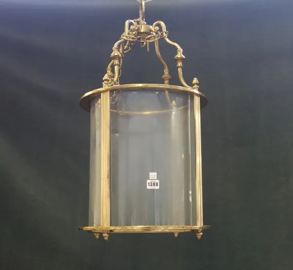A Victorian style gilt metal hall lantern, 20th century, of circular form, with clear glass panels, 65cm high.