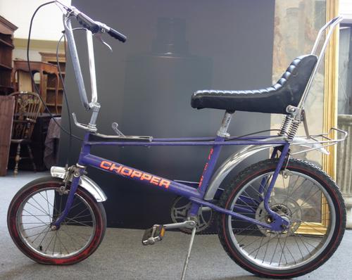 A vintage 'Raleigh Chopper' child's pushbike, purple, fluro orange, (a.f).