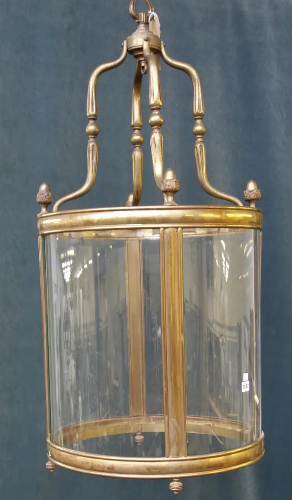 A Victorian style gilt bronze hall lantern, 20th century, of circular form, with four fluted shaped supports and acorn cast finials, 110cm high.
