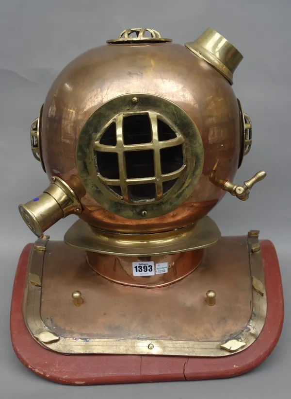 A reproduction deep sea diver's helmet, late 20th century, copper and brass, on a painted wooden plinth, 44cm high.